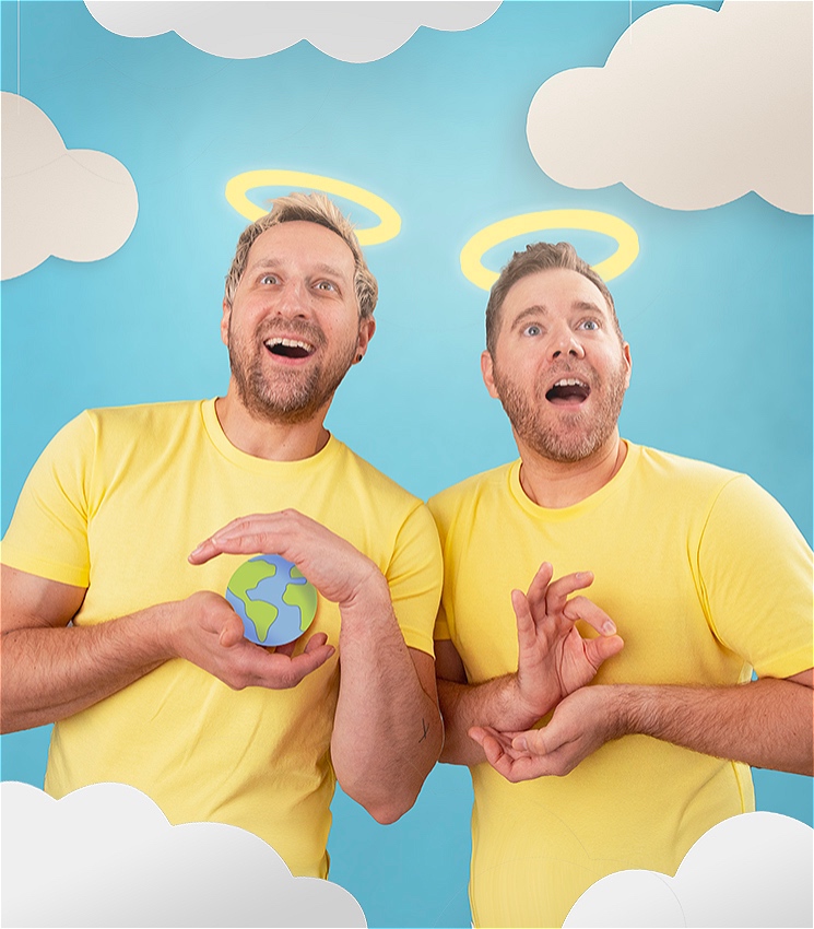 Two men wearing yellow tee shirts on a blue background, with cutout paper clouds in front of them at the bottom of the frame. They stare out wondrously into the distance and both have halos illuminated above their heads. The man on the left holds a small cartoon globe of the earth, and the man on the right holds his hands in a religious pose.