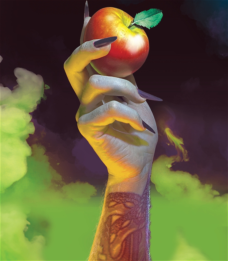 A tattooed arm with long nails appears from green smoke holding a red apple