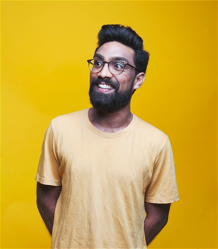 Suren Jayemanne with yellow shirt and yellow background. Suren is smiling